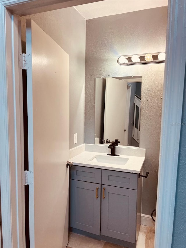 bathroom featuring tile patterned flooring and vanity