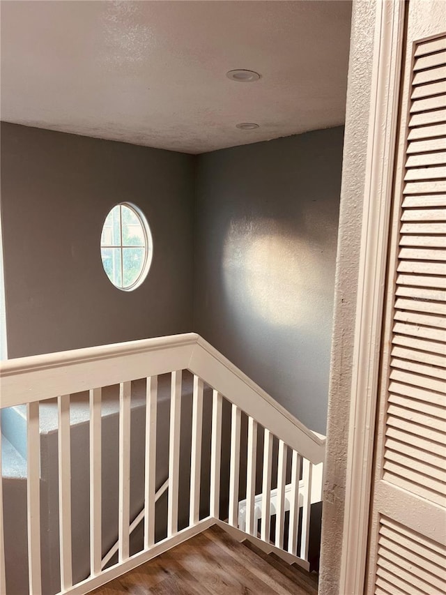 stairs featuring hardwood / wood-style floors