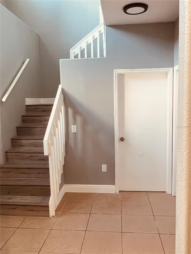 staircase featuring tile patterned floors