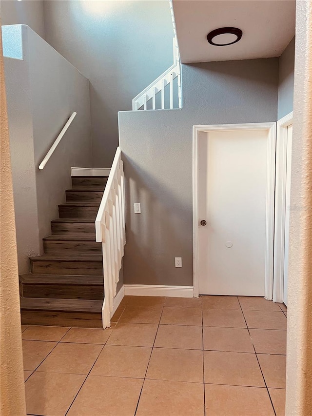 stairway with tile patterned floors