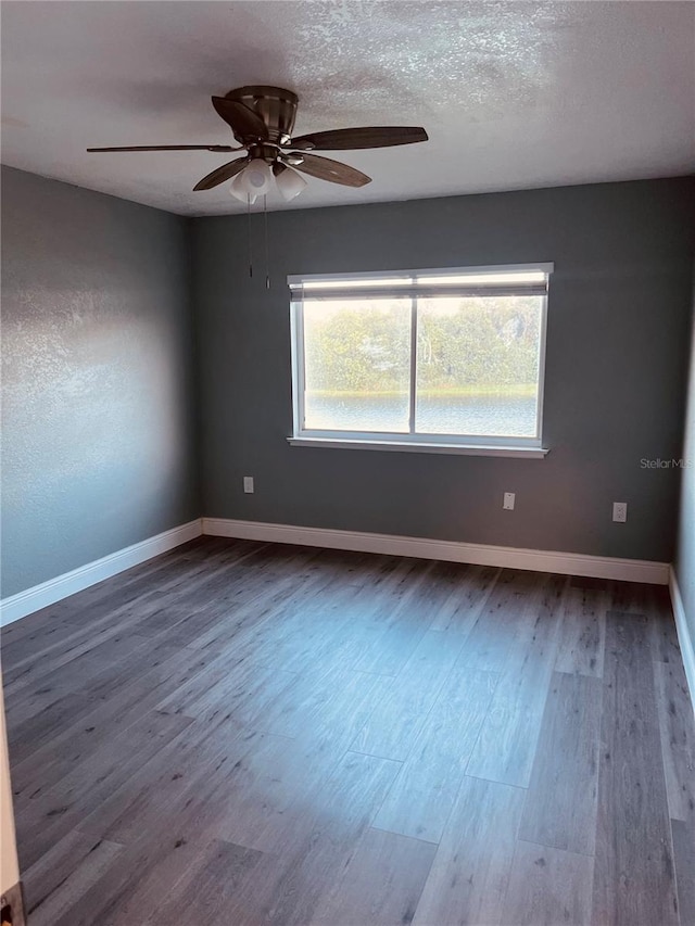 spare room featuring a textured ceiling, hardwood / wood-style floors, and ceiling fan