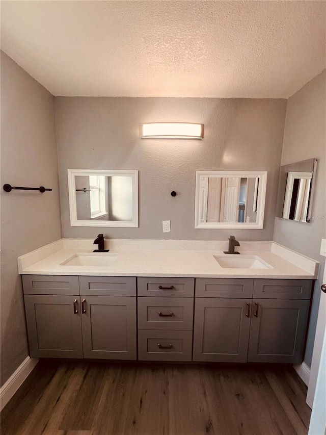 bathroom featuring vanity, a textured ceiling, and hardwood / wood-style flooring