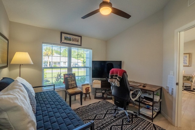 office featuring lofted ceiling, ceiling fan, and light hardwood / wood-style flooring