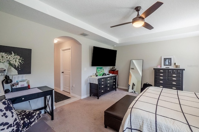 carpeted bedroom with ceiling fan and a textured ceiling