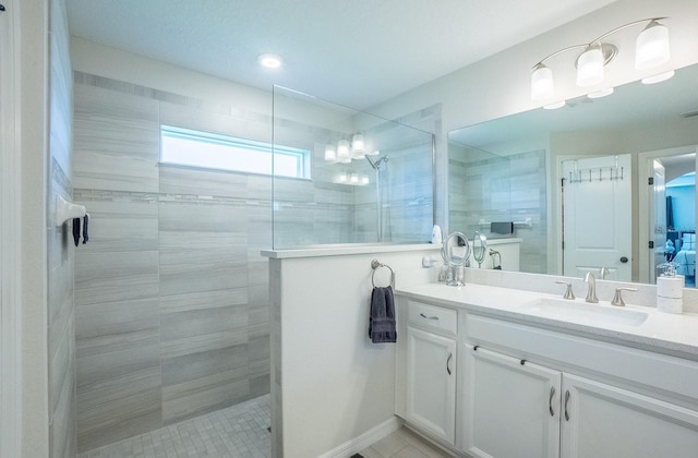 bathroom with vanity and tiled shower