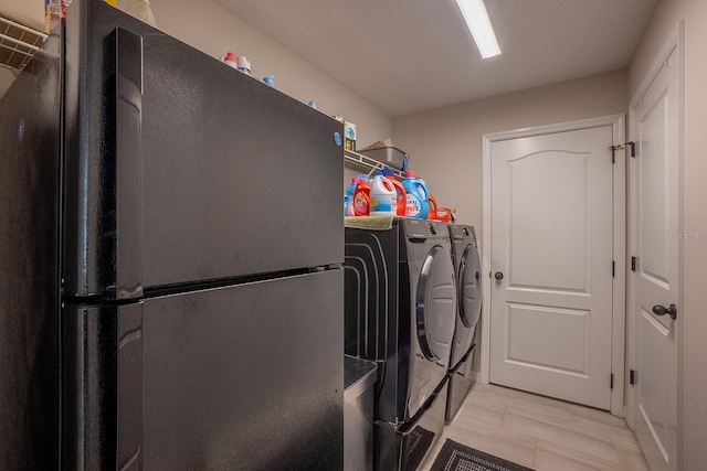 laundry room featuring light hardwood / wood-style flooring and washer and dryer