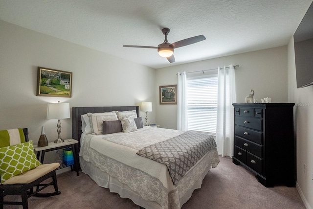 bedroom featuring ceiling fan, a textured ceiling, and carpet