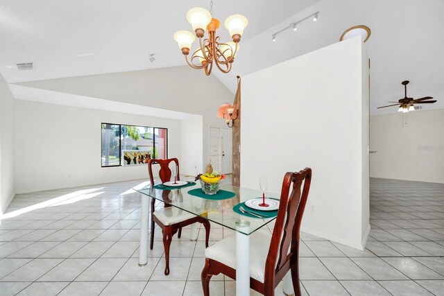 tiled dining area featuring ceiling fan with notable chandelier, high vaulted ceiling, and rail lighting