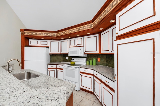 kitchen featuring sink, backsplash, white appliances, light tile patterned floors, and light stone countertops