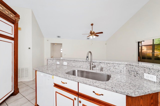 kitchen with dishwasher, light tile patterned floors, light stone countertops, ceiling fan, and sink