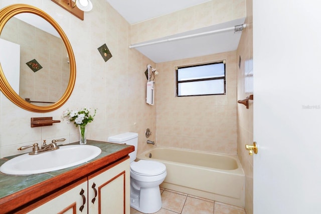 full bathroom featuring tile walls, vanity, tiled shower / bath combo, tile patterned flooring, and toilet