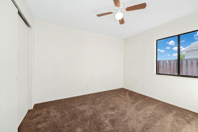 unfurnished room with ceiling fan and carpet floors