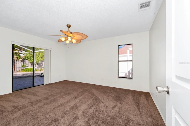 spare room featuring carpet flooring, ceiling fan, and a wealth of natural light