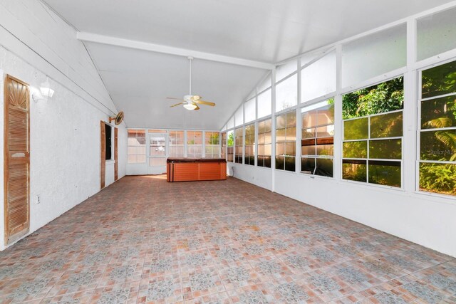 unfurnished sunroom with lofted ceiling with beams and ceiling fan