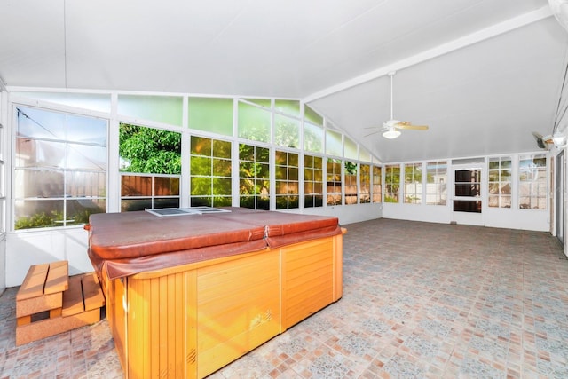 interior space with ceiling fan and vaulted ceiling with beams