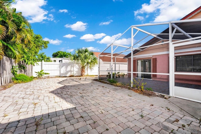 view of patio / terrace with a lanai