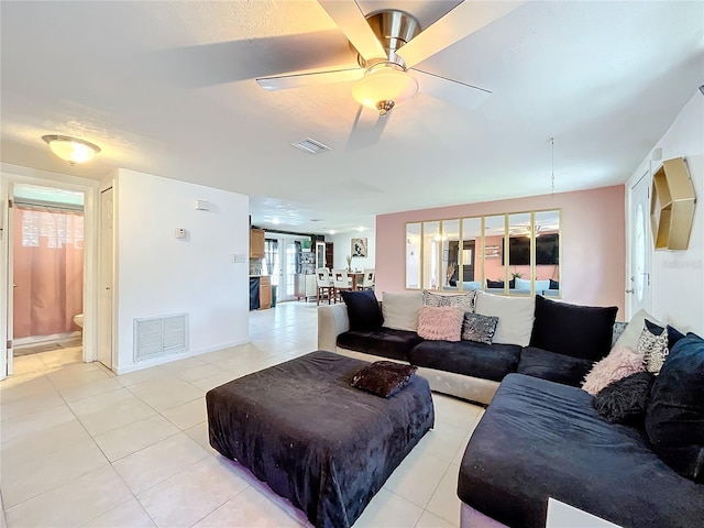 tiled living room featuring ceiling fan