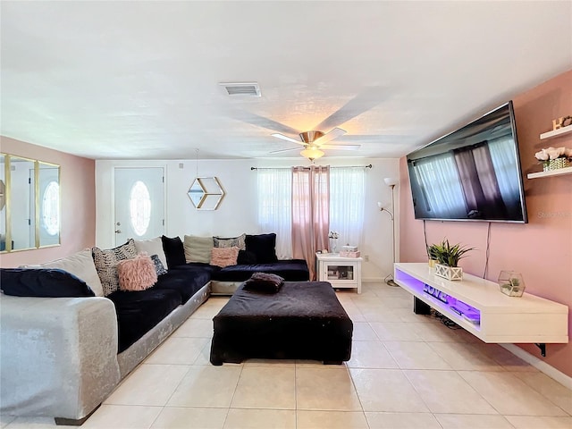 living room featuring light tile patterned flooring, ceiling fan, and plenty of natural light