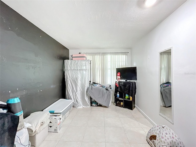 interior space with a textured ceiling and light tile patterned floors