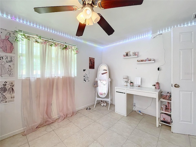 office area with light tile patterned floors and ceiling fan