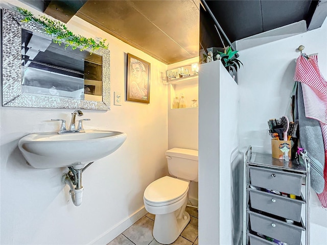 bathroom featuring tile patterned flooring and toilet