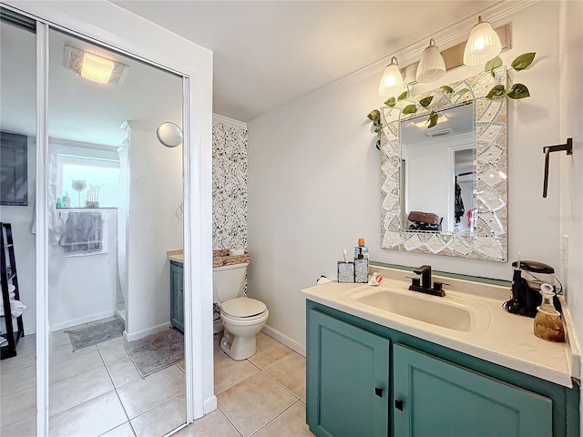 bathroom featuring ornamental molding, vanity, toilet, and tile patterned floors