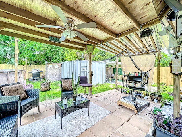 view of patio / terrace with a storage shed, ceiling fan, and grilling area