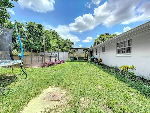 view of yard with a trampoline