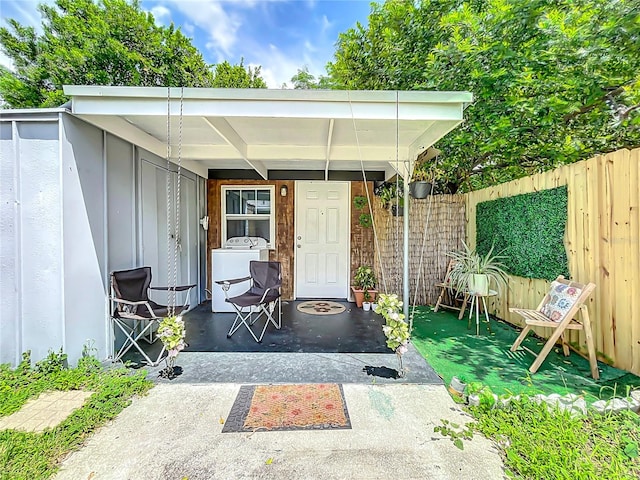 entrance to property featuring a patio area