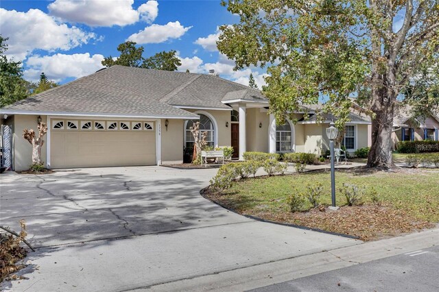 ranch-style home with a garage and a front yard