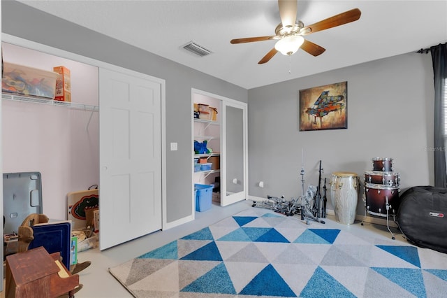 interior space with ceiling fan