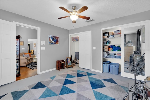 bedroom featuring a textured ceiling and ceiling fan