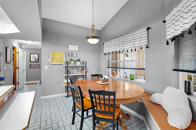 dining area featuring lofted ceiling