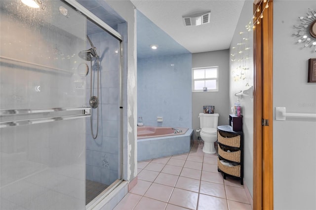 bathroom featuring a textured ceiling, tile patterned floors, shower with separate bathtub, and toilet