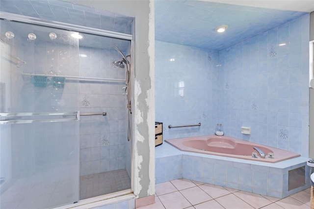 bathroom featuring tile patterned floors, shower with separate bathtub, and tile walls