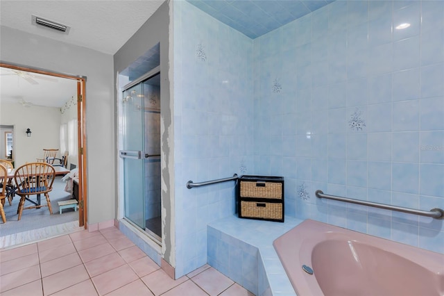 bathroom featuring separate shower and tub, tile walls, tile patterned floors, and ceiling fan