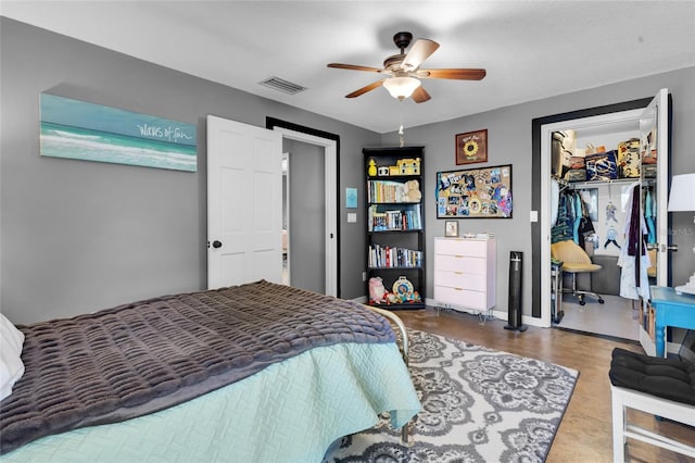 bedroom with ceiling fan, a spacious closet, and a closet