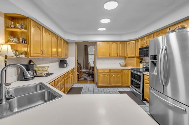 kitchen featuring stainless steel appliances, sink, and backsplash