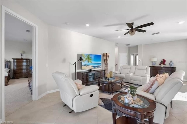 living room featuring light tile patterned floors and ceiling fan