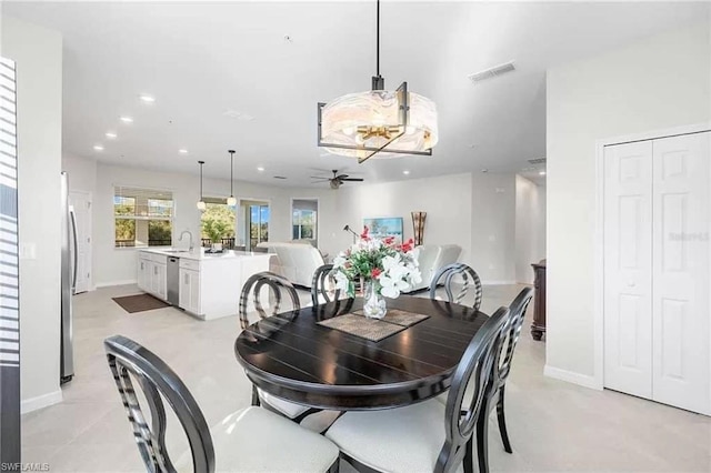 dining space with ceiling fan and sink