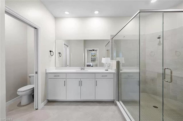 bathroom with vanity, toilet, and an enclosed shower