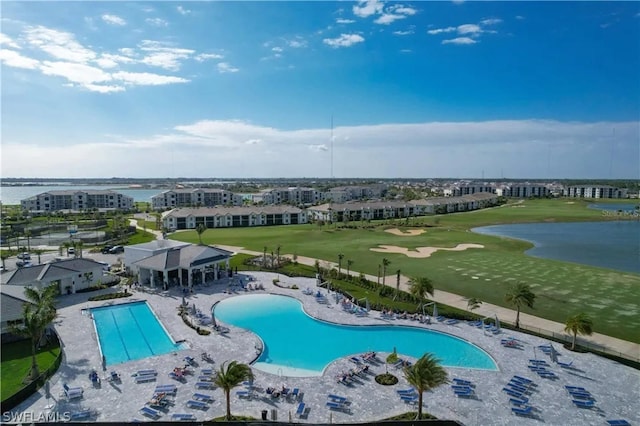 view of pool featuring a water view and a patio area