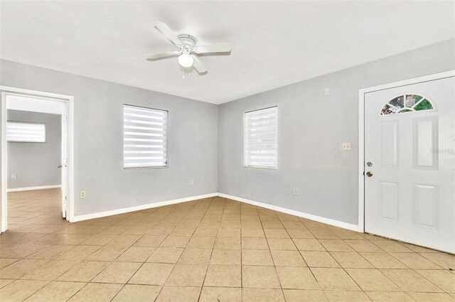 tiled entryway featuring ceiling fan and a healthy amount of sunlight