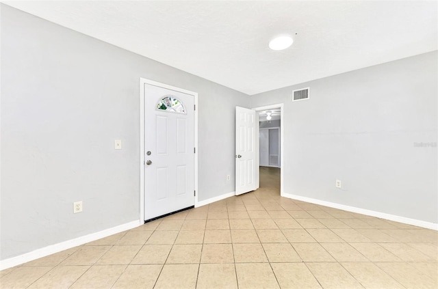 tiled spare room with a textured ceiling