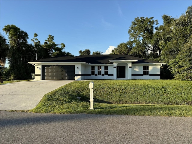 ranch-style home with a garage and a front yard