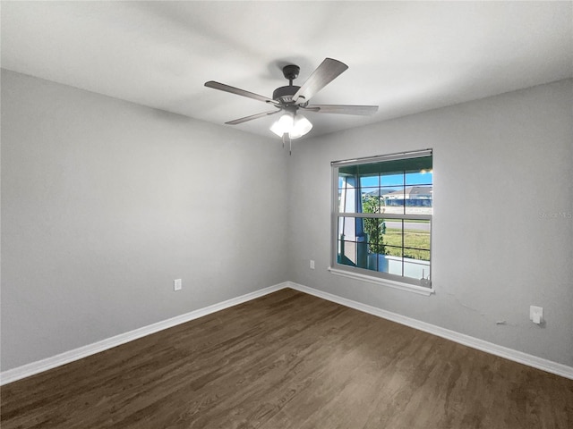 empty room with ceiling fan and dark hardwood / wood-style floors