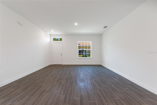 spare room with dark hardwood / wood-style flooring