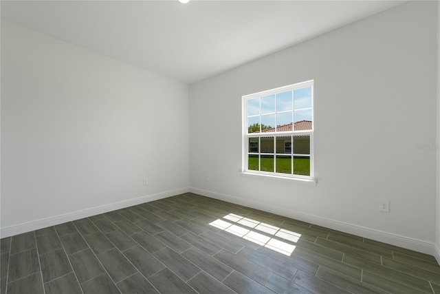 unfurnished room with dark hardwood / wood-style floors