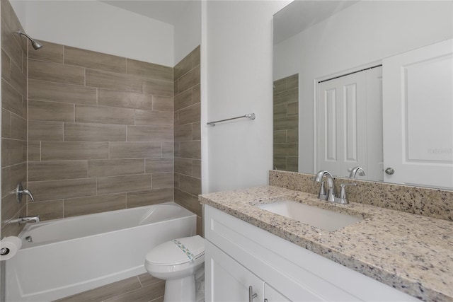 full bathroom with tiled shower / bath combo, vanity, toilet, and hardwood / wood-style flooring