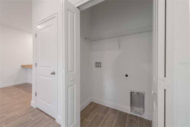 clothes washing area with hookup for a washing machine, hardwood / wood-style floors, and electric dryer hookup